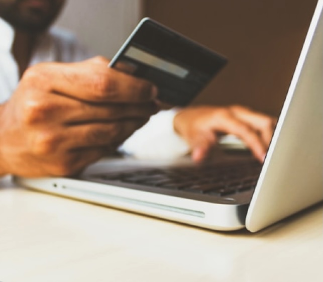 A person holding a credit card for donating money